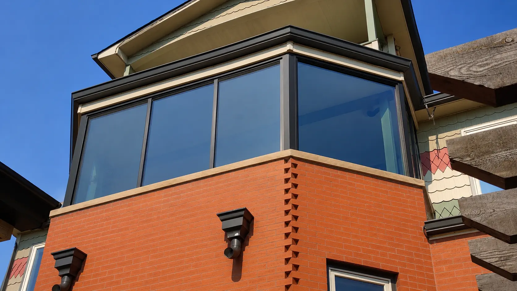 Exterior view of a home addition enclosed by large windows